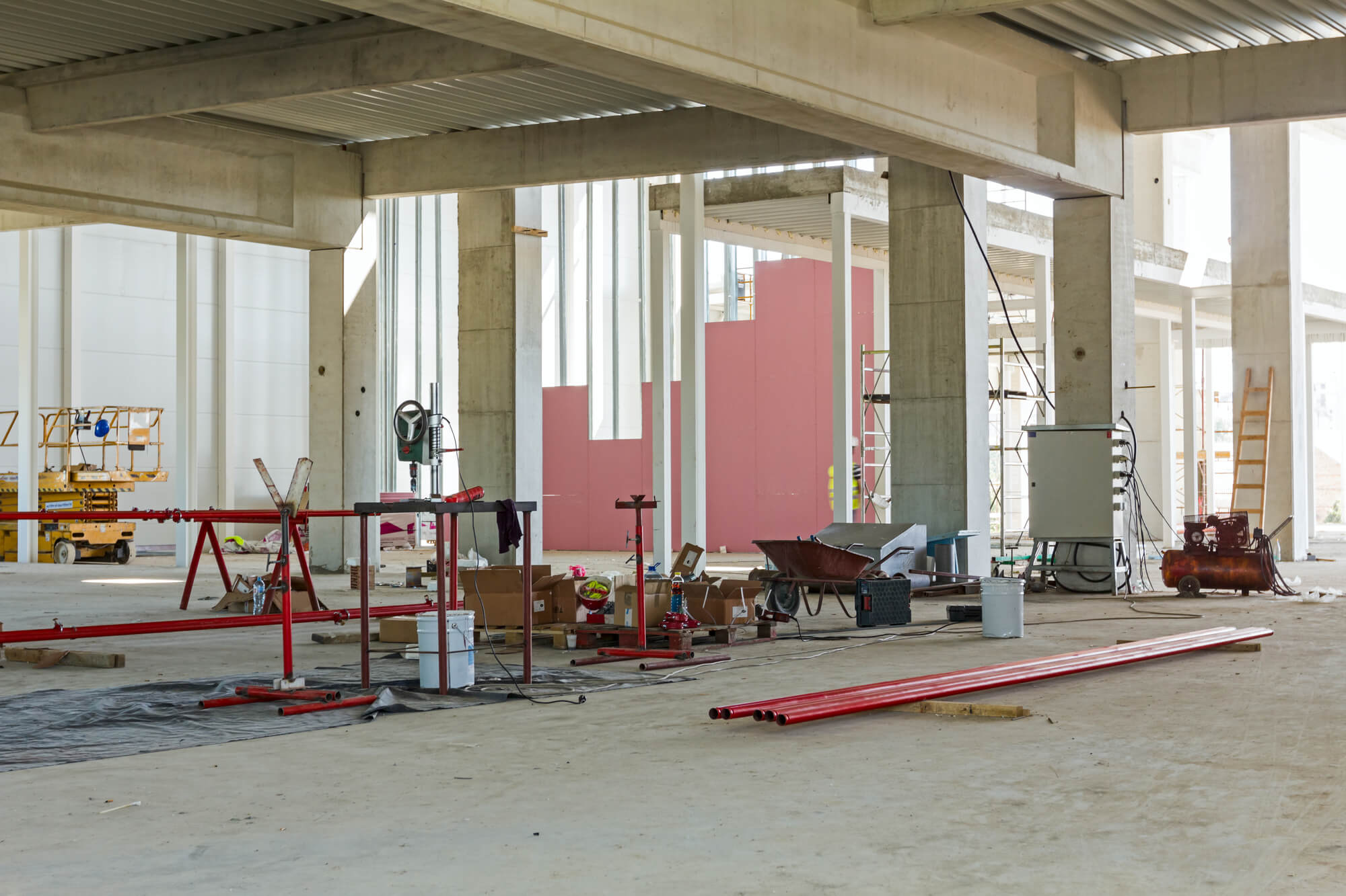 Provisional workshop for assembly red pipeline for extinguishing water is placed in the industrial building.