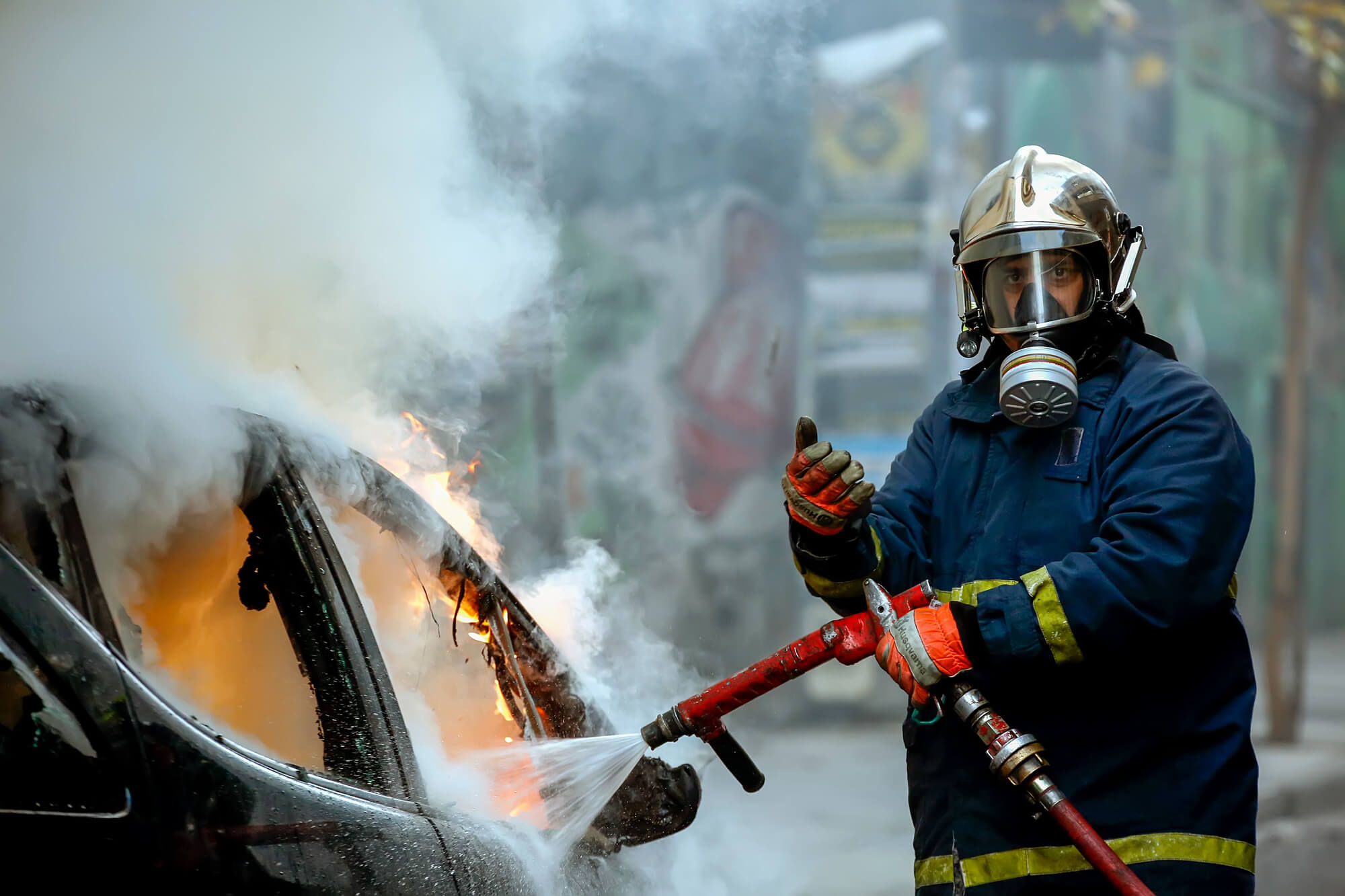 Athens, Greece - February 4, 2016: Firemen fighting a flaming car after an explosion