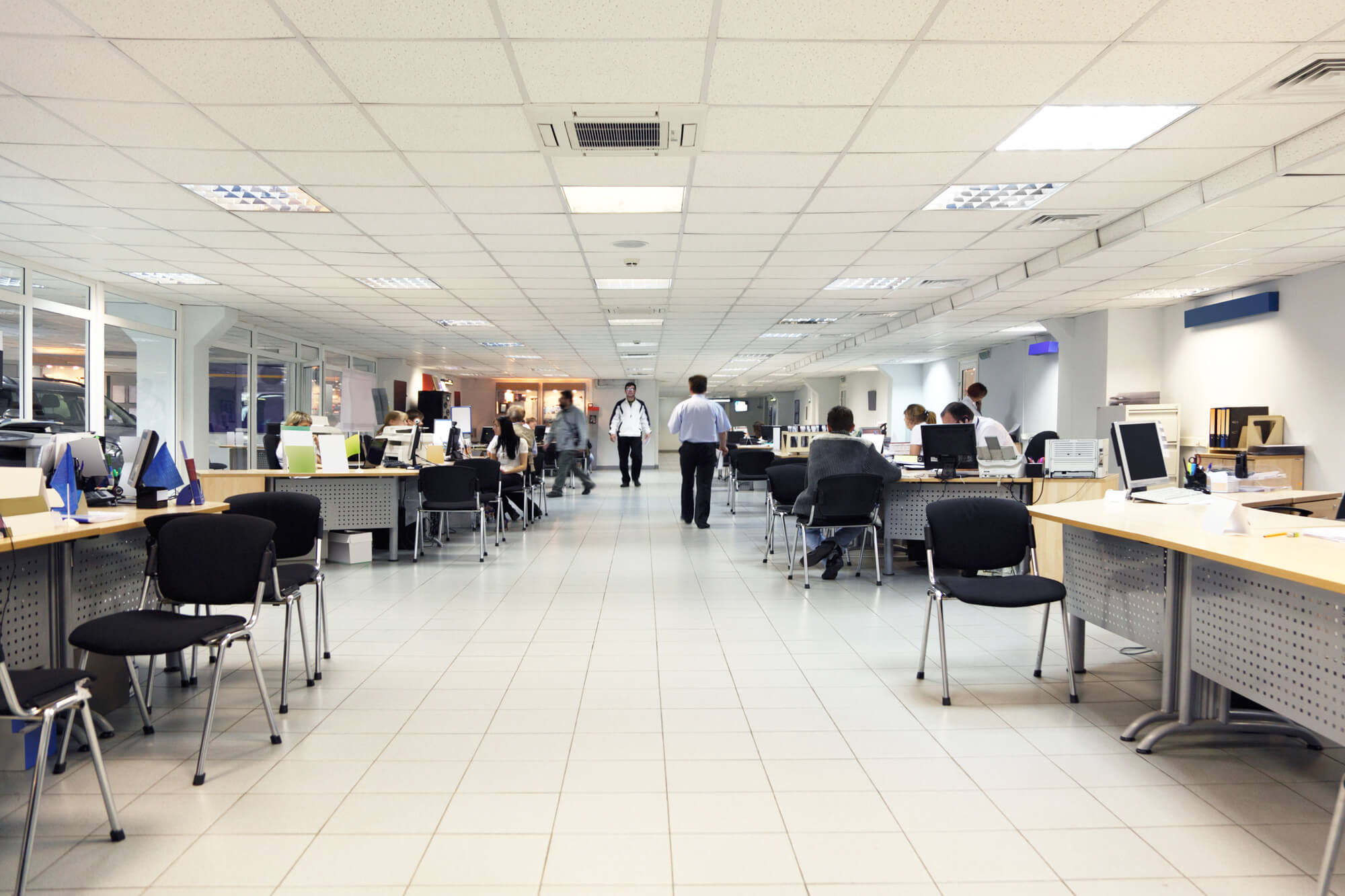 office with white floor and celling, people working on computers, inserted released faces