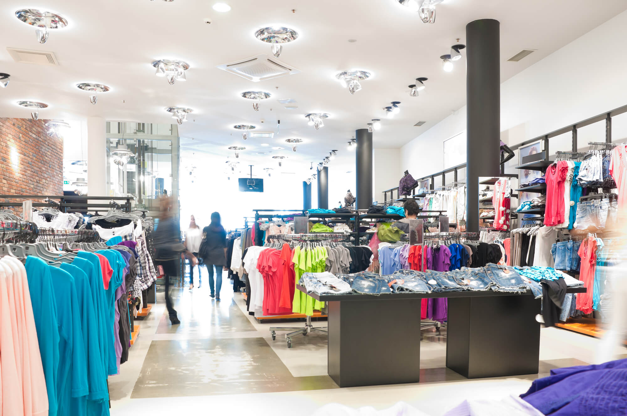 interior of the modern clothes shop. Image overexposed by intent, all customers blured